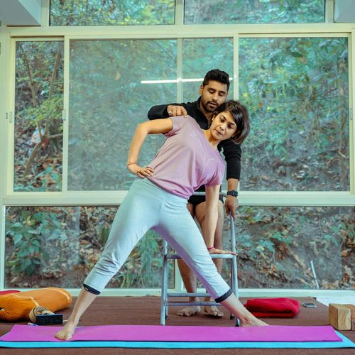 Professional yoga instructor smiling warmly.